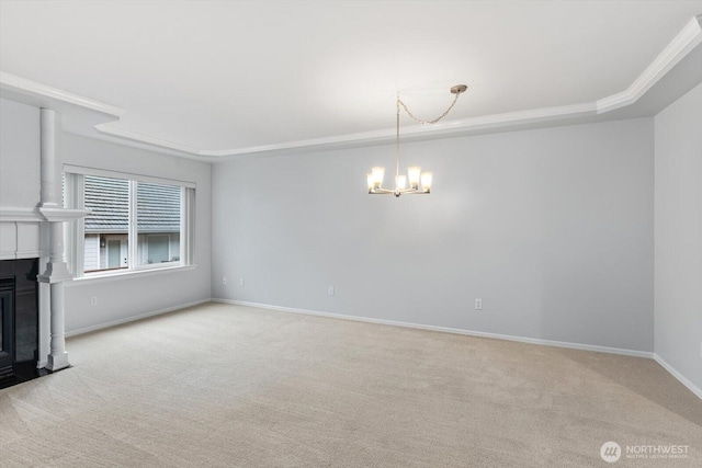 unfurnished living room with a fireplace with flush hearth, an inviting chandelier, baseboards, and carpet