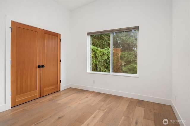 unfurnished bedroom with light wood-type flooring and baseboards