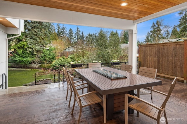 view of patio with outdoor dining area and fence