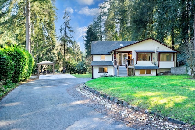 view of front of house featuring driveway and a front lawn