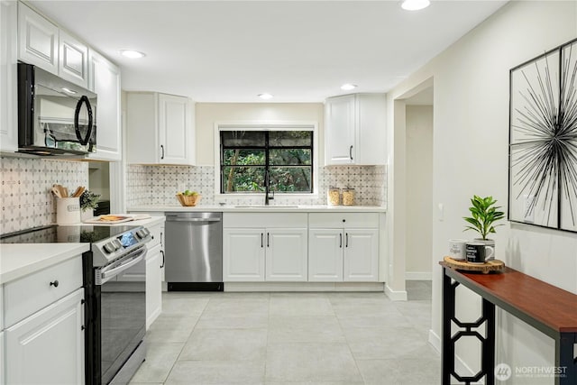 kitchen with range with electric stovetop, stainless steel dishwasher, white cabinetry, a sink, and black microwave