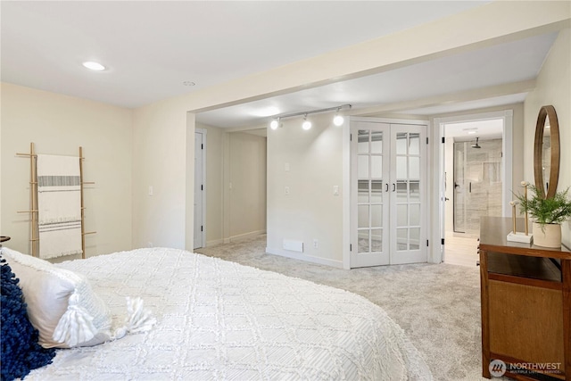 carpeted bedroom featuring baseboards, connected bathroom, and french doors