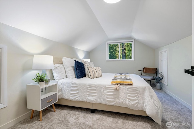 bedroom with vaulted ceiling, carpet, and baseboards