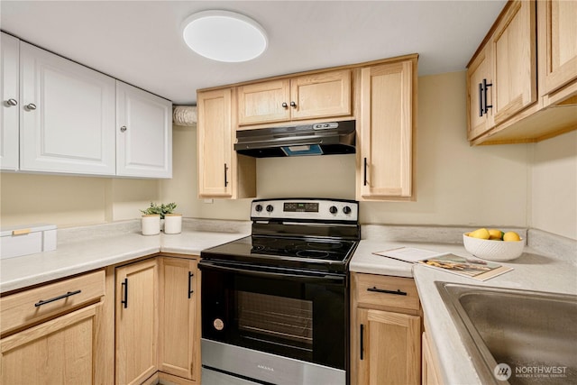 kitchen with stainless steel electric range, light countertops, under cabinet range hood, light brown cabinets, and a sink