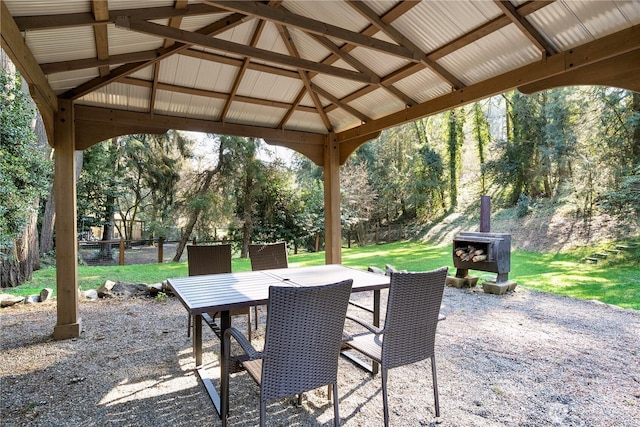 view of patio / terrace featuring a gazebo, outdoor dining space, and fence