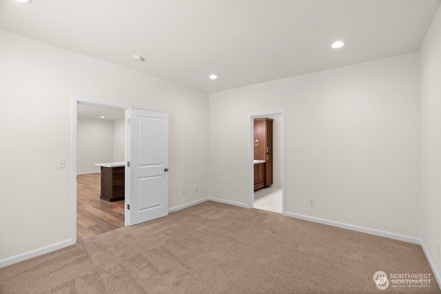 unfurnished room featuring baseboards, recessed lighting, and light colored carpet