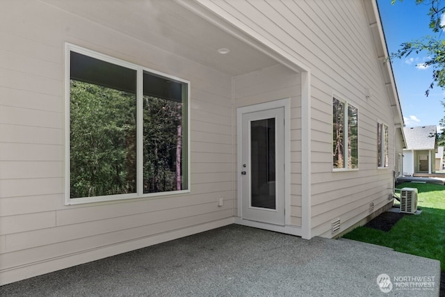 doorway to property with crawl space, a patio, and central AC unit