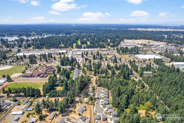 birds eye view of property with a wooded view