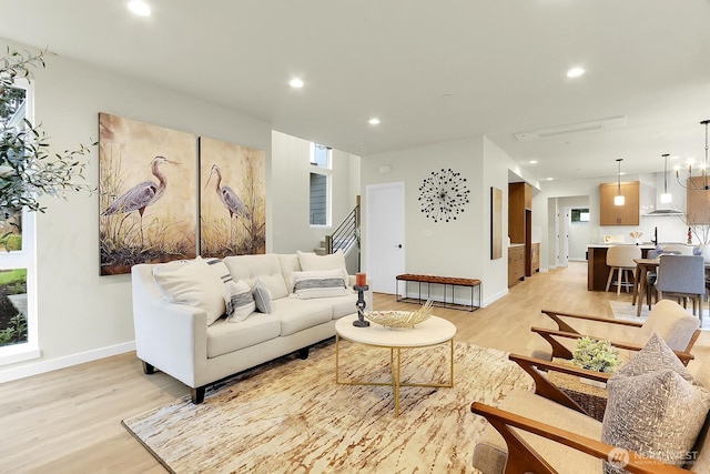 living room featuring light wood-style floors, baseboards, and recessed lighting