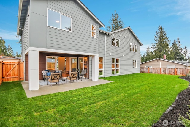 rear view of house featuring a fenced backyard, a patio, an outdoor living space, and a lawn