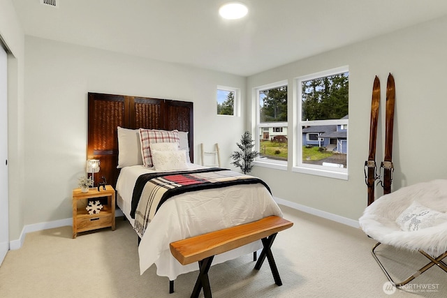 carpeted bedroom with baseboards