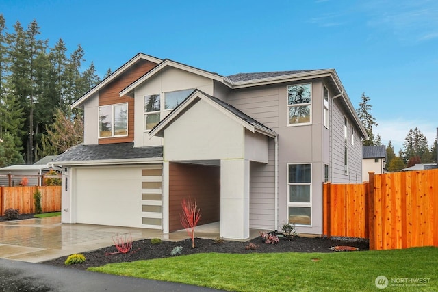 view of front of house with a garage, decorative driveway, fence, and a shingled roof