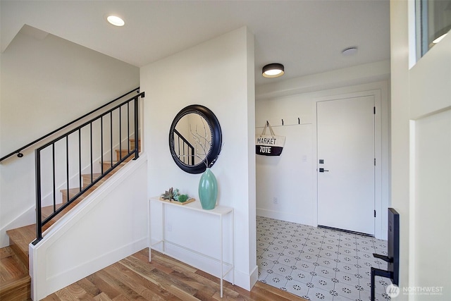 entrance foyer featuring recessed lighting, baseboards, and stairs