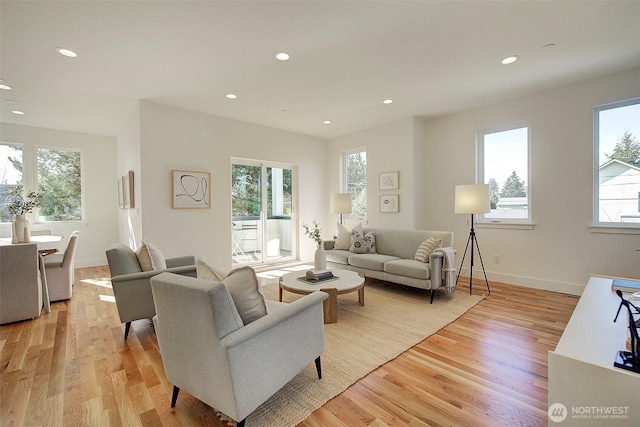 living room with light wood-type flooring, baseboards, and recessed lighting