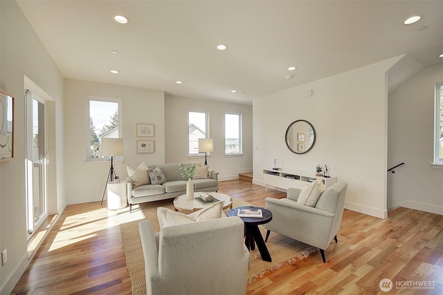 living room with light wood-type flooring, baseboards, and recessed lighting