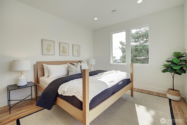 bedroom with light wood-style flooring, baseboards, and recessed lighting