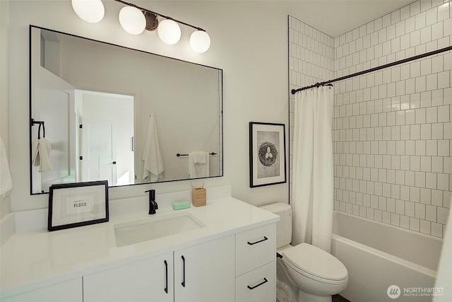 bathroom with shower / tub combo, vanity, and toilet