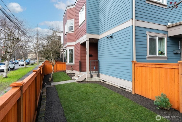 exterior space featuring fence and a yard