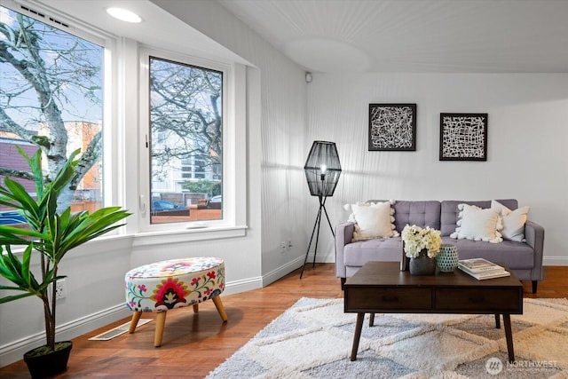 living room featuring wood finished floors and baseboards