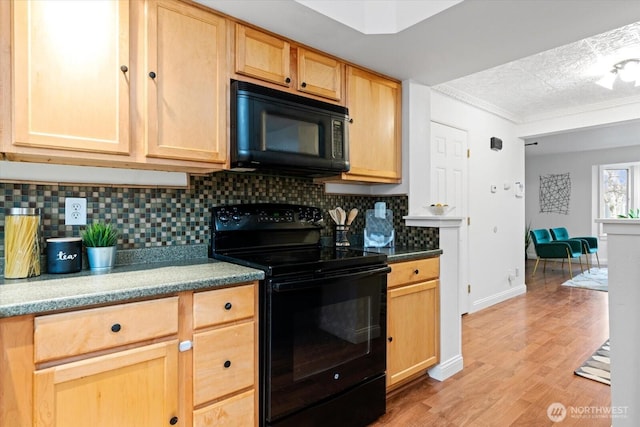 kitchen with black appliances, light brown cabinets, light wood finished floors, and backsplash