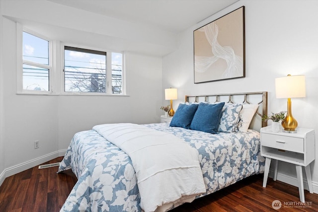 bedroom with dark wood-style floors and baseboards