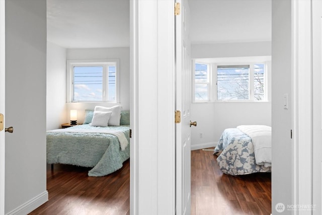 bedroom with baseboards and wood finished floors