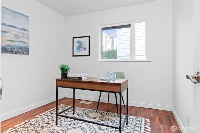 office space with visible vents, baseboards, and wood finished floors