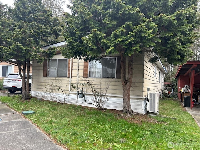 view of front of house featuring a front yard and central air condition unit