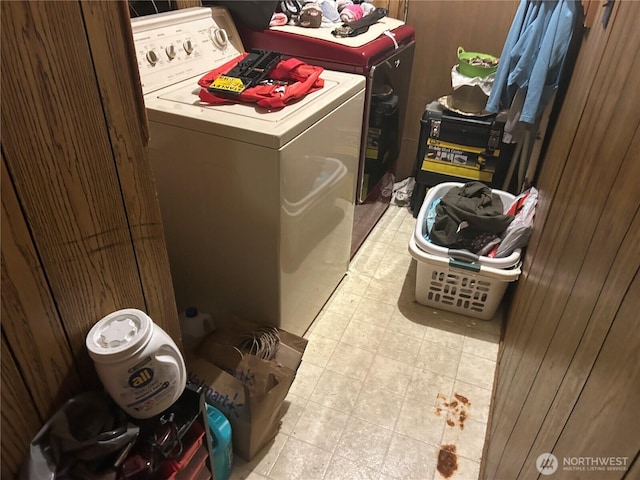 washroom featuring laundry area, light floors, and separate washer and dryer