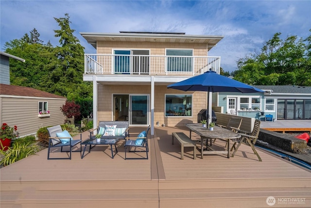 back of house featuring an outdoor living space and a balcony