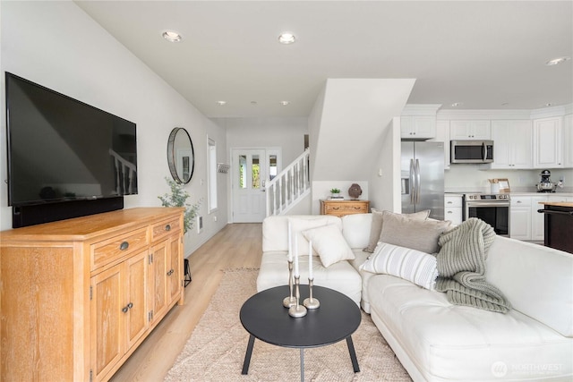 living area featuring stairway, recessed lighting, and light wood-type flooring