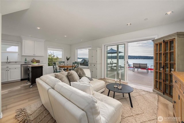 living area with recessed lighting and light wood-style floors