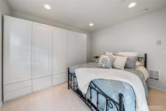 bedroom featuring recessed lighting, visible vents, and light carpet