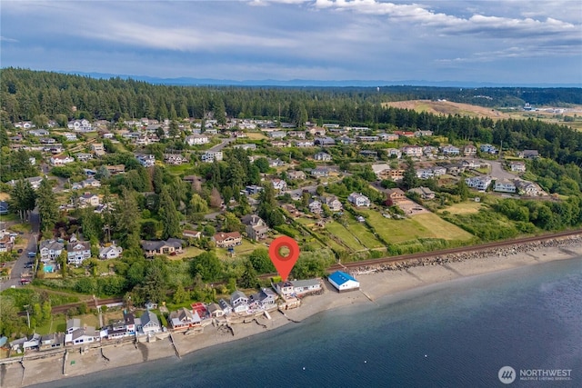 birds eye view of property with a forest view and a water view