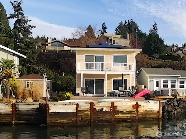 rear view of house with a balcony and a patio area