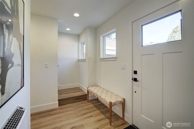 foyer with recessed lighting, light wood-style flooring, and baseboards