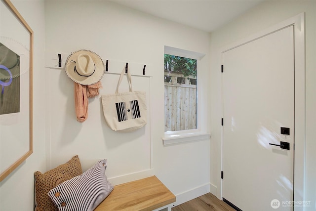 mudroom with wood finished floors and baseboards