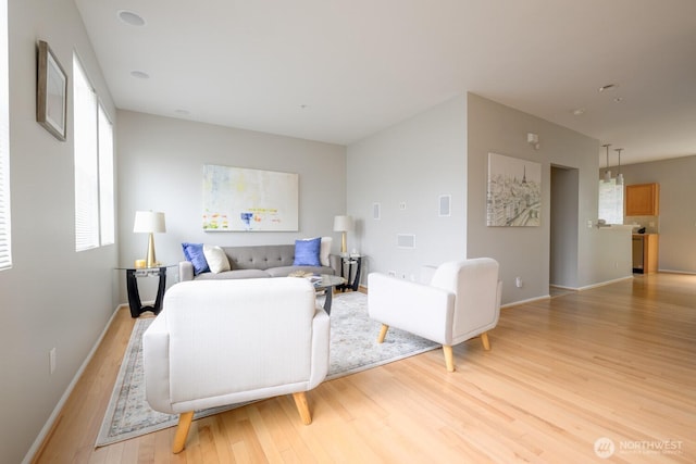 living area with light wood finished floors and baseboards