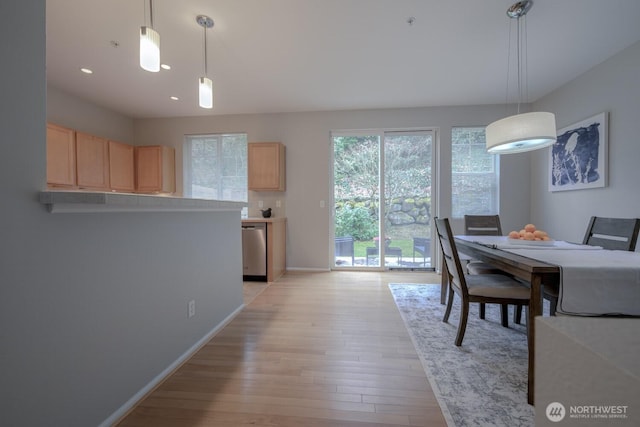 dining room featuring recessed lighting, baseboards, and light wood finished floors