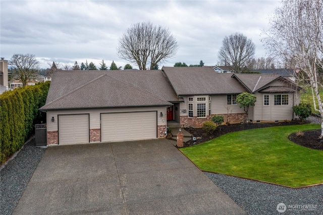 view of front of property featuring brick siding, a shingled roof, a front yard, a garage, and driveway