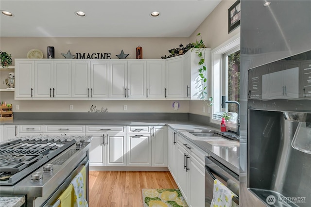 kitchen with light wood-type flooring, white cabinets, open shelves, and recessed lighting