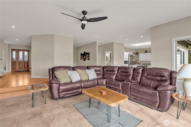 living area with a ceiling fan, recessed lighting, a healthy amount of sunlight, and light tile patterned floors