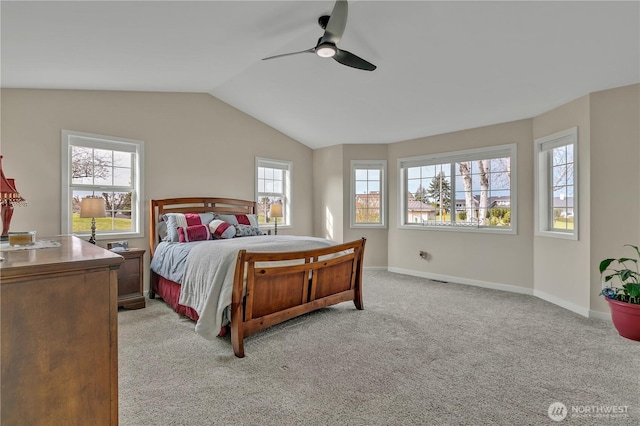 bedroom featuring light colored carpet, vaulted ceiling, baseboards, and ceiling fan