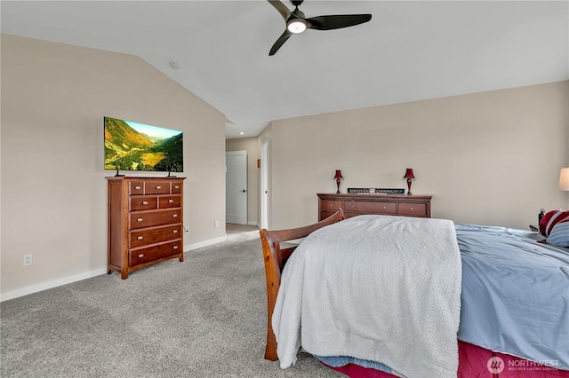 carpeted bedroom featuring a ceiling fan, vaulted ceiling, and baseboards