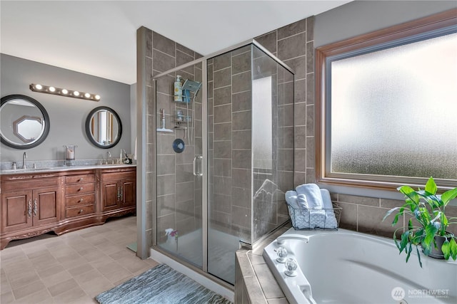 full bath featuring a garden tub, double vanity, a stall shower, and a sink