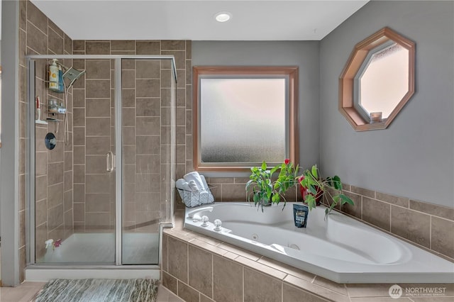 full bathroom featuring a shower stall and a whirlpool tub