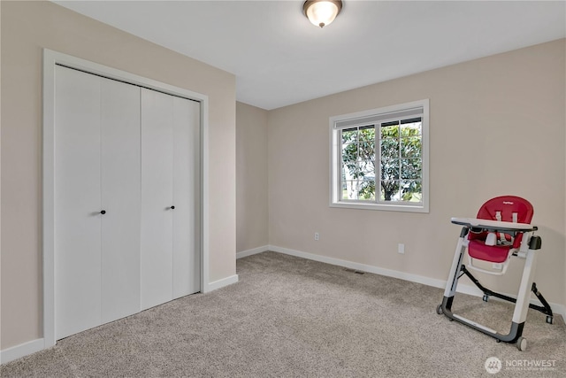 interior space with carpet, visible vents, and baseboards