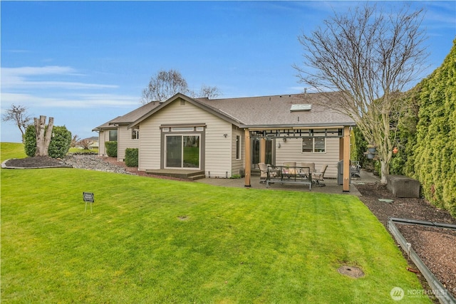 rear view of property with a patio, a lawn, and roof with shingles