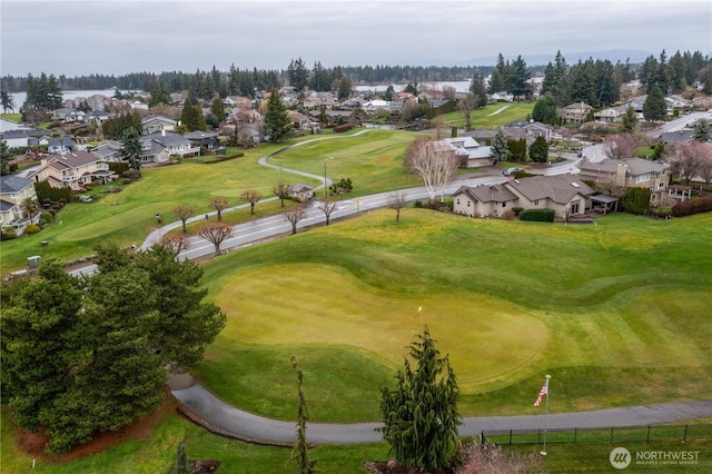 birds eye view of property featuring view of golf course and a residential view