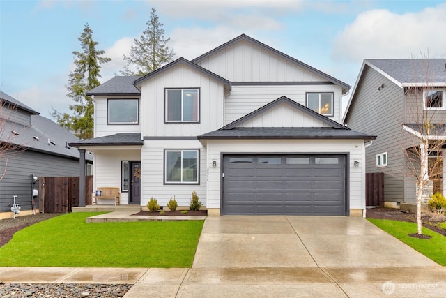 view of front of property with driveway, a garage, fence, board and batten siding, and a front yard